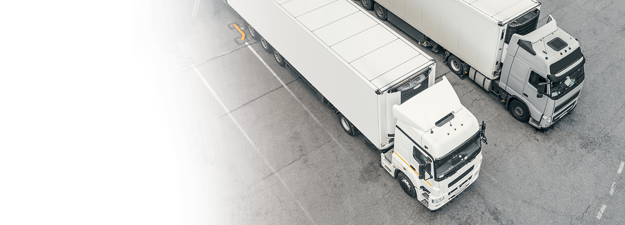 Dwa samochody ciężarowe zaparkowane obok siebie